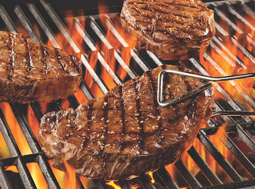 ribeye steaks on the grill