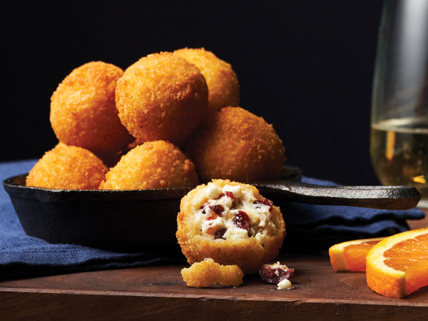 Premium Photo  Cheese balls with garlic and dill inside for a snack in a  plate on a black background